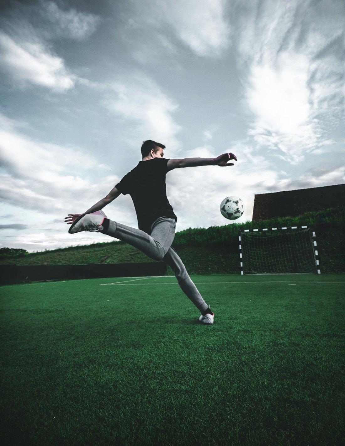 Jovem atleta da Base Forte chutando a bola